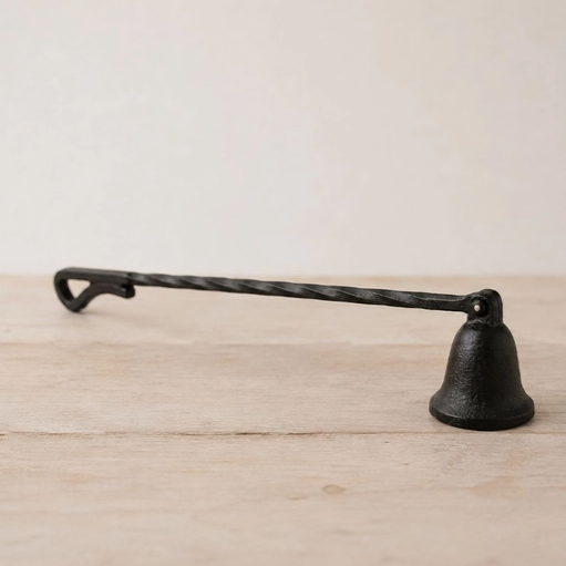 Cast iron candle snuffer with a long twisted handle and bell-shaped hood⠋