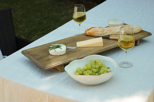 A beautifully styled rustic table setting with handcrafted serving boards and tableware