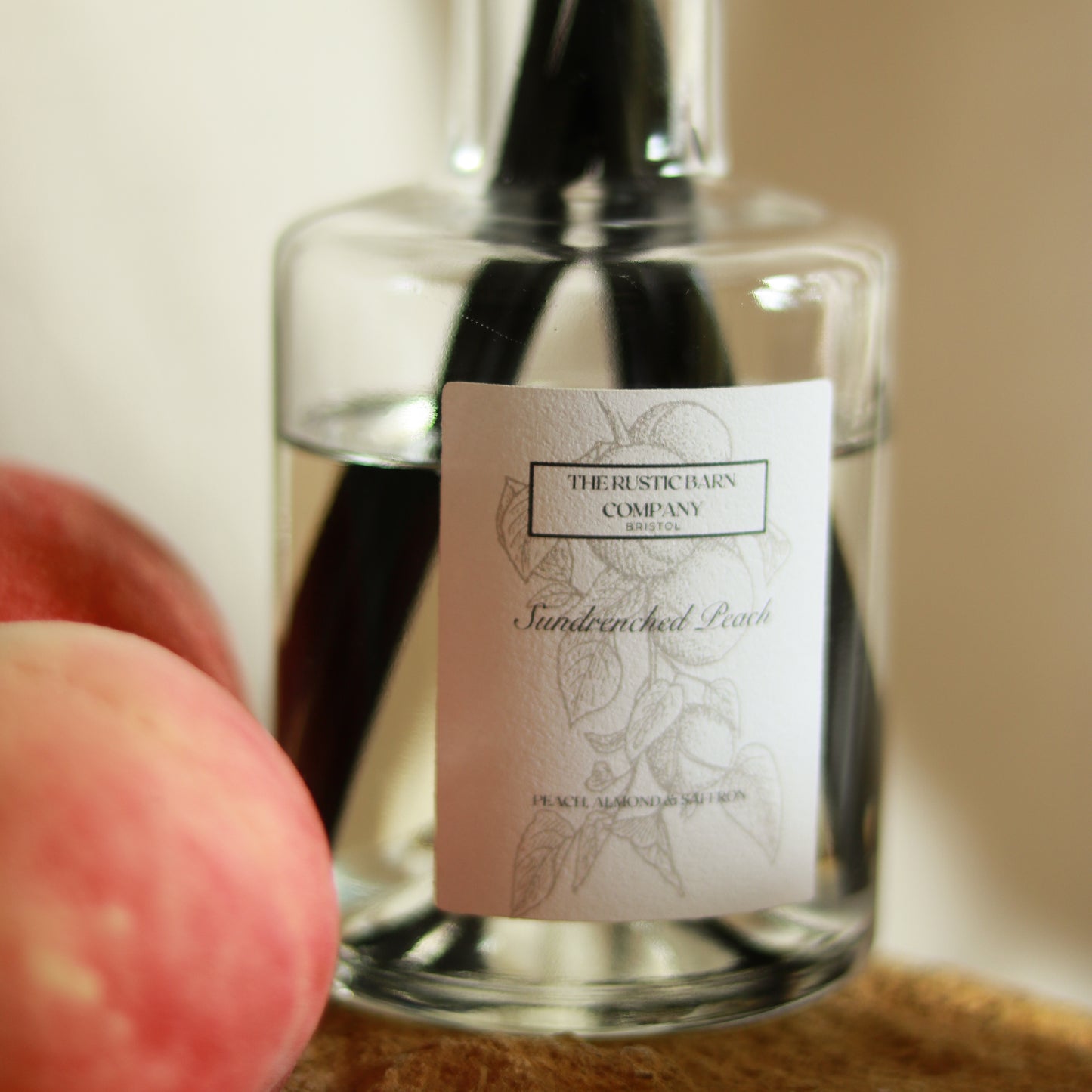 Close-up of the Sundrenched Peach label on a 200ml reed diffuser by The Rustic Barn Company