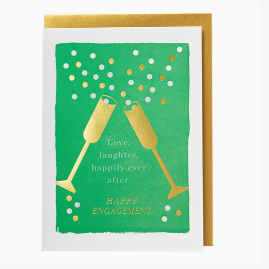 A square greeting card with a green front design featuring two gold champagne glasses, white and gold confetti dots, and the text 'Love, laughter, happily-ever after. HAPPY ENGAGEMENT.