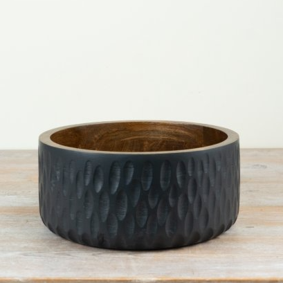 A dark charcoal gray hammered wood bowl with a warm brown wood interior, resting on a light wooden surface against a plain off-white background.