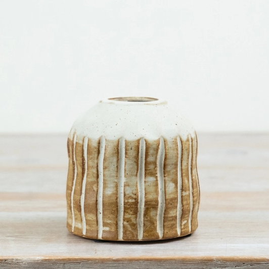Natural ribbed ceramic vase with a white glaze over a warm brown body, shown straight on against a plain background