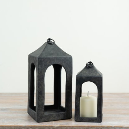 Large and small rustic ceramic lanterns styled together, with an ivory pillar candle inside the smaller lantern