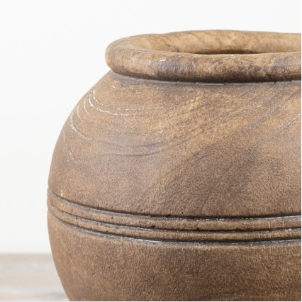 Close view of the rimmed lip and incised line detail on a rustic handcrafted brown vase