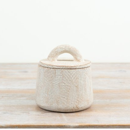 Cement storage pot in soft off-white with deeply scored texture and an arched handle on the lid, viewed from a slight angle
