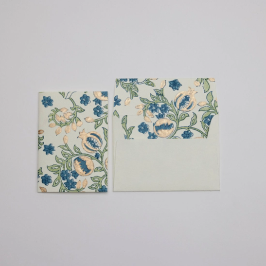 A matching stationery set featuring a small rectangular card and a square envelope with a vintage botanical print in blue, green, and beige on an off-white background.